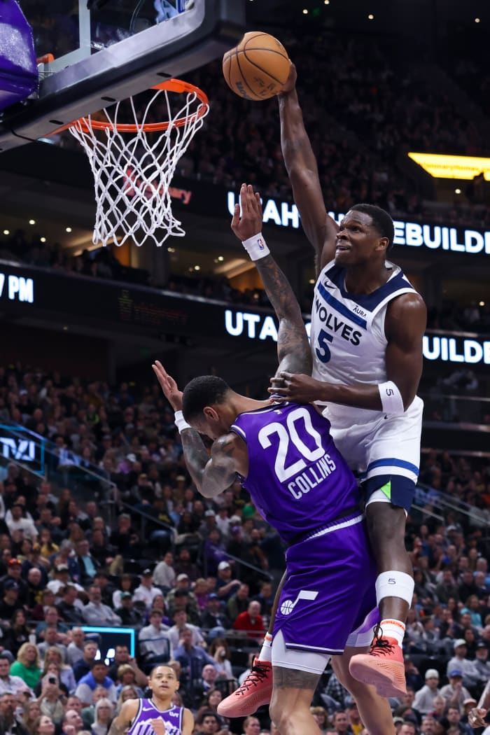 Minnesota Timberwolves guard Anthony Edwards (5) dunks the ball against Utah Jazz forward John Collins (20) during the third quarter at Delta Center in Salt Lake City on March 18, 2024.